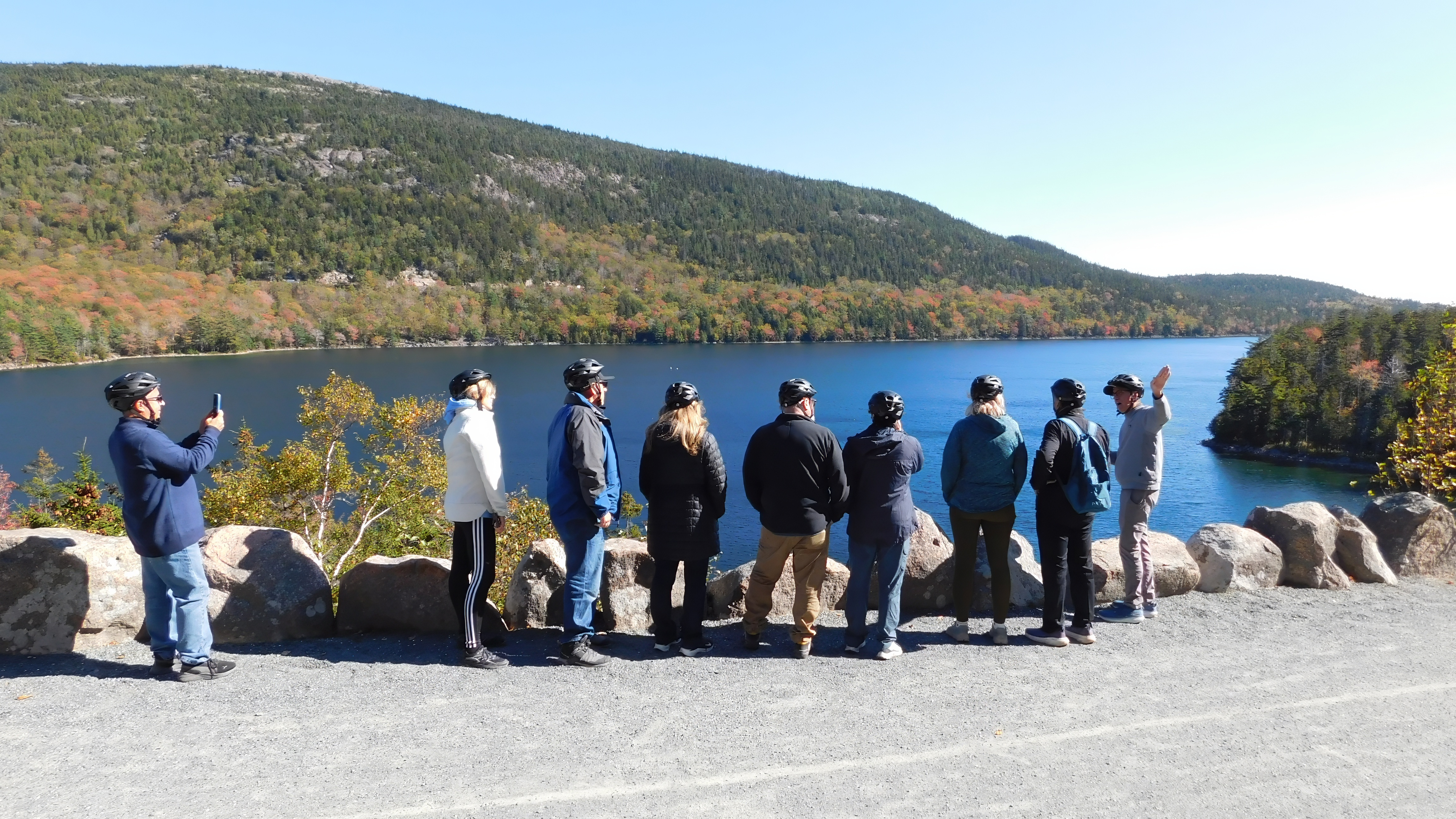 Guided e-bike tour group at a carriage road overlook in Acadia National Park